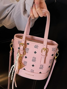 Pink bucket bag with classic bear print and gold accents, stylish crossbody for women