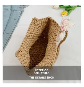 Detail view showing the handwoven straw texture and open-top interior of the tote bag