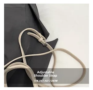 Detail of adjustable cream leather shoulder strap with silver buckle on a bag