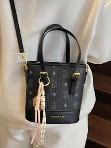 Classic black monogram bucket bag with gold hardware and woven charm for women