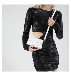 Close-up of white pebble leather crossbody bag with FASHION & BAGS gold lettering