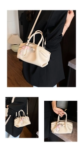 Detail showing the creamy beige lychee texture and pleated design of this elegant tote bag