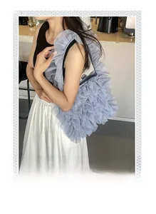 Detailed view of dusty blue layered mesh tote bag with ruffled lace design on shoulder