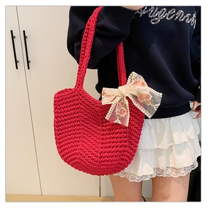 Detail of hand-woven magenta crochet tote bag featuring a floral lace ribbon bow accent
