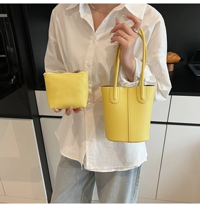 Detail of yellow lychee texture bucket bag set including small zipper pouch and long handles