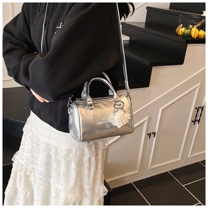 Dettaglio della borsa Boston argento metallizzato con ciondolo di perla e logo