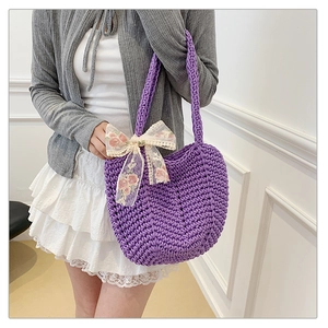 Detail of purple woven tote bag with delicate lace bow and floral embroidery details