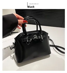 Detailed view of glossy black mini square bag with silver hardware and dual handles