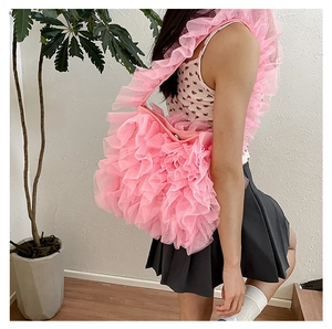 Detailed close-up of pink layered mesh pleats and ruffled shoulder strap of the tote bag