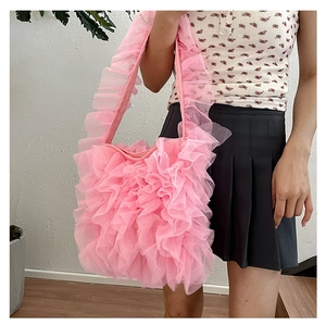 Close-up of pink pleated lace tote bag with layered ruffle details and airy mesh fabric