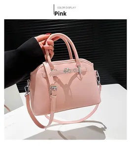 Pink faux leather tote bag with silver metal buckles and detachable shoulder strap