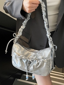 Silver metallic pleated shoulder bag with bow and beads for a chic look