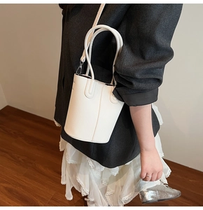 White bucket bag with lychee texture pattern shown in a lifestyle model shot