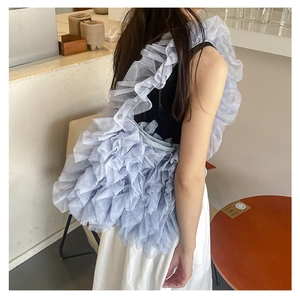 Detail view of the soft light blue ruffled lace shoulder bag with layered pleats texture