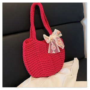 Detail of hand-woven magenta cotton tote bag featuring a floral lace bow accent