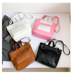 Flat lay of four crocodile-embossed tote bags with skull patterns in various colors