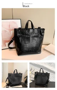 Detail of black tote bag featuring embossed skull patterns and crocodile texture trim