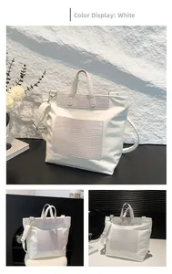White tote bag with skull embossing, crocodile texture accents and adjustable shoulder strap