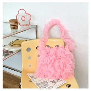 Close-up of pink ruffle tulle tote bag with tiered organza pleats and soft texture