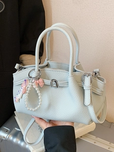 Minimalist light blue pleated leather tote bag with pearl bow charm and silver buckle