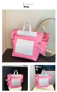 Detail view of pink embossed skull tote bag with white crocodile texture accents