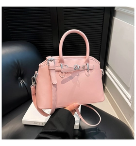 Detail of pink oil wax leather handbag featuring matte finish and decorative belt buckle strap
