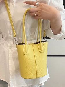 Vibrant yellow bucket bag with lychee texture and detachable shoulder strap for women