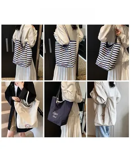 Close-up of stylish striped canvas tote bags with cute puppy embroidery for daily use