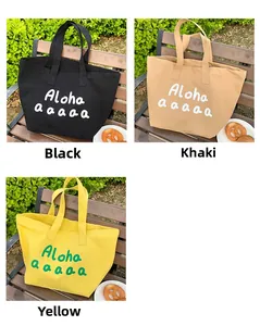 Three large canvas tote bags with Aloha print in black, khaki and yellow shown in park