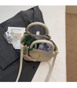 Vue de dessus d'un sac seau blanc crème avec motif litchi montrant l'intérieur spacieux