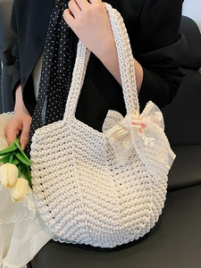 Off-white knit crochet tote bag with pink floral embroidery and lace bow accent