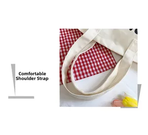 Close-up of comfortable wide canvas shoulder straps on a beige tote bag with fine stitching