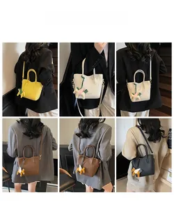 Detail view of lychee pattern leather bucket bags in yellow, white, brown and black colors