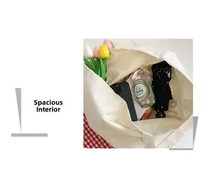 Top view of spacious cream canvas tote bag interior holding daily essentials like umbrella and book