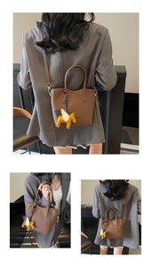 Brown lychee leather tote bag with elegant pegasus charm and detachable shoulder strap