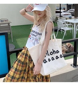 Detail shot of canvas tote bag with black Aloha print and long shoulder straps