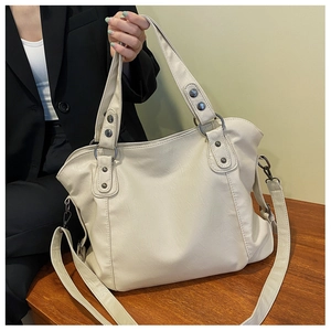Large cream faux leather tote bag with retro metal rivets and adjustable shoulder strap