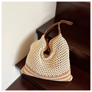 Detail of hand-woven tote bag with brown stripes resting on vintage wooden steps