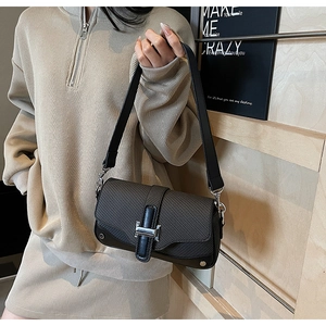 Detail of contrast stitch handbag with silver H-buckle and textured fabric material