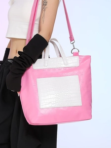Pink skull embossed tote bag with white crocodile pattern accents and crossbody strap