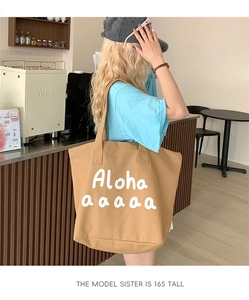 Canvas tote bag with Aloha print shown on 165cm model for size scale reference