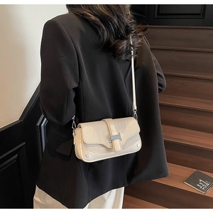 Close-up of beige crossbody bag featuring woven texture and silver H-shaped buckle clasp