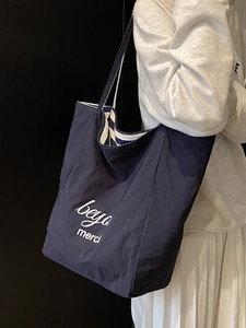 Large dark blue canvas tote bag with white lettering for women's daily commute