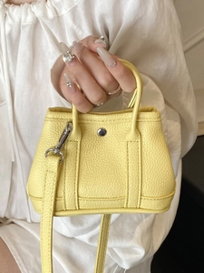 Mini yellow lychee pattern leather handbag with silver clasp and crossbody strap