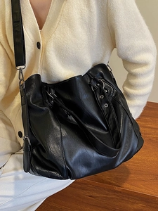 Large black pebbled leather tote bag with silver ring hardware for women's daily commute