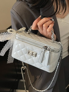 Quilted blue crossbody bag with pearl handle and white lace bow detail for women