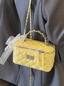 Elegant yellow quilted leather vanity bag with chain strap and lace pearl accessories