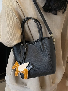 Minimalist black lychee pattern leather bucket bag with a stylish pegasus charm