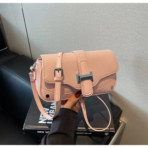 Close-up of pink crossbody bag featuring PU leather and woven texture with H-shaped buckle