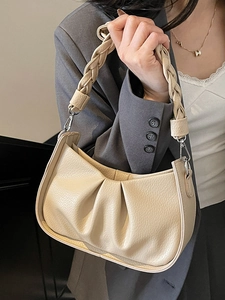 Minimalist beige pleated underarm bag with woven handle for women fashion styling